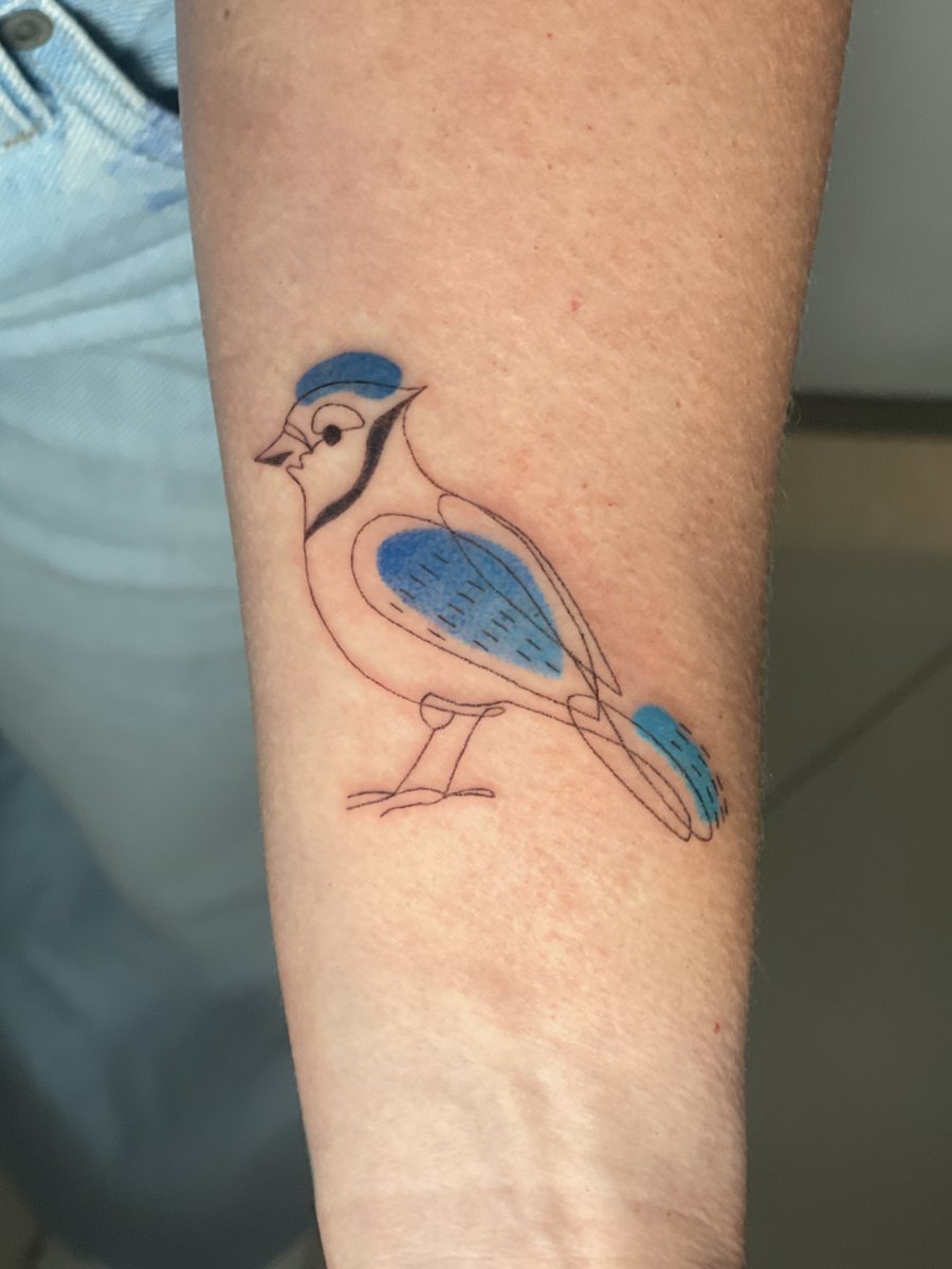 Fine line blue jay hand poke tattoo with blue color on a forearm, Puerto Rico