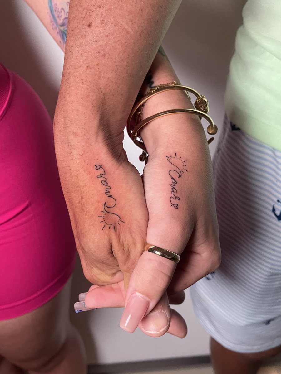 Matching hand poke script tattoos on two hands, Puerto Rico