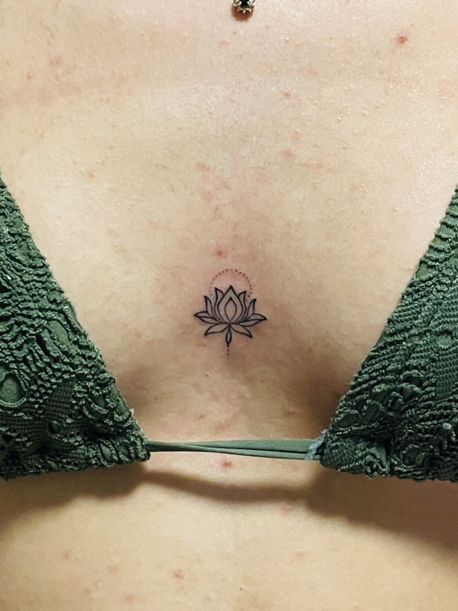 Micro lotus flower fine line hand poke tattoo on the sternum, Puerto Rico